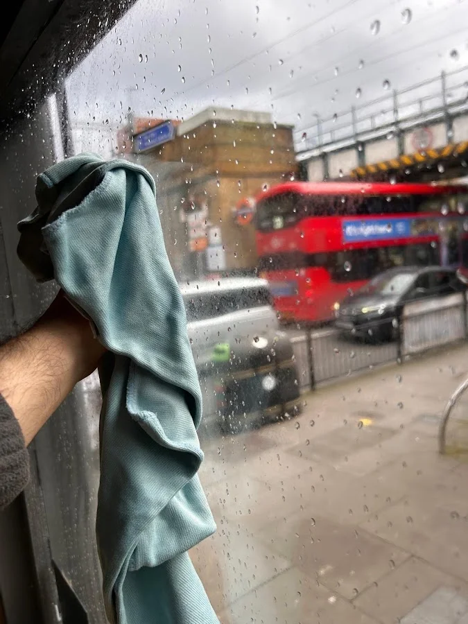Window cleaning in action — wiping glass to a perfect finish